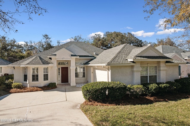 view of front of home with a front yard and a garage