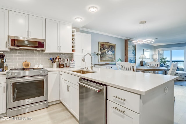 kitchen featuring pendant lighting, kitchen peninsula, sink, and stainless steel appliances