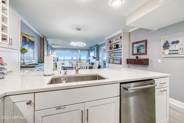 kitchen featuring kitchen peninsula, white cabinetry, stainless steel dishwasher, and decorative light fixtures