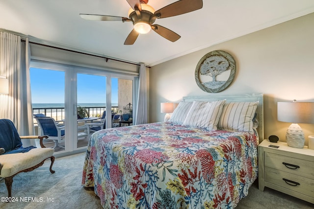 carpeted bedroom featuring access to outside, ceiling fan, crown molding, and a water view