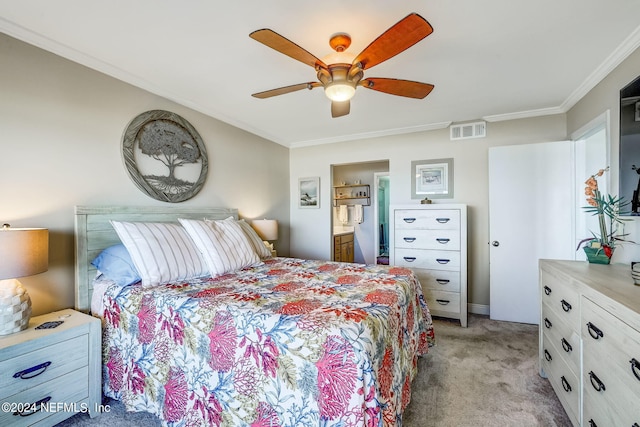 bedroom with ceiling fan, crown molding, light colored carpet, and ensuite bathroom