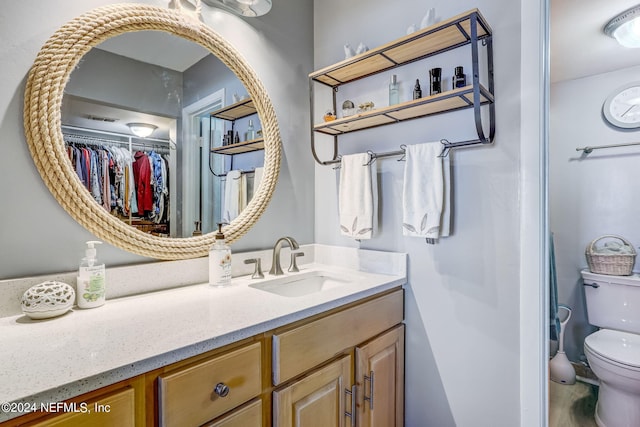 bathroom with vanity and toilet