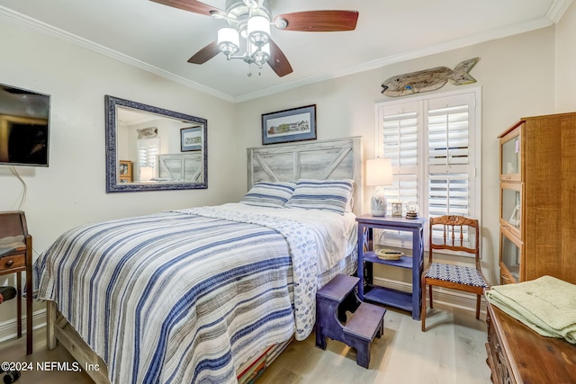 bedroom featuring ceiling fan, wood-type flooring, and ornamental molding