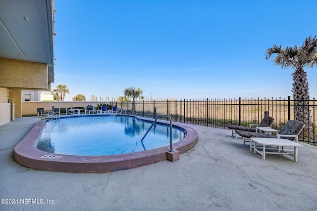 view of swimming pool featuring a patio area