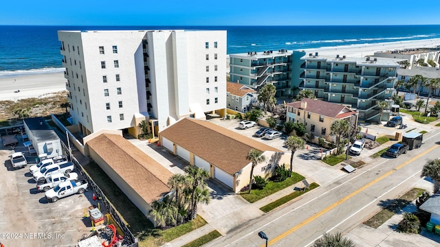 bird's eye view featuring a water view and a beach view