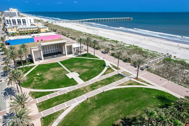 drone / aerial view with a water view and a beach view