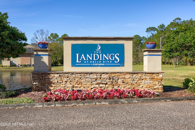 community / neighborhood sign with a water view