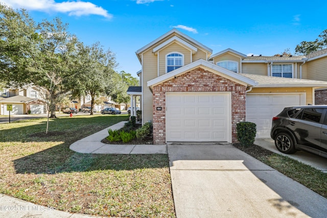 view of front of property with a garage and a front lawn