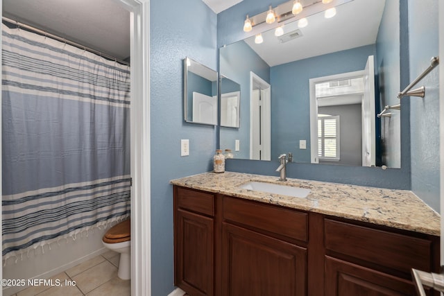 full bathroom featuring tile patterned floors, vanity, toilet, and shower / bath combo with shower curtain