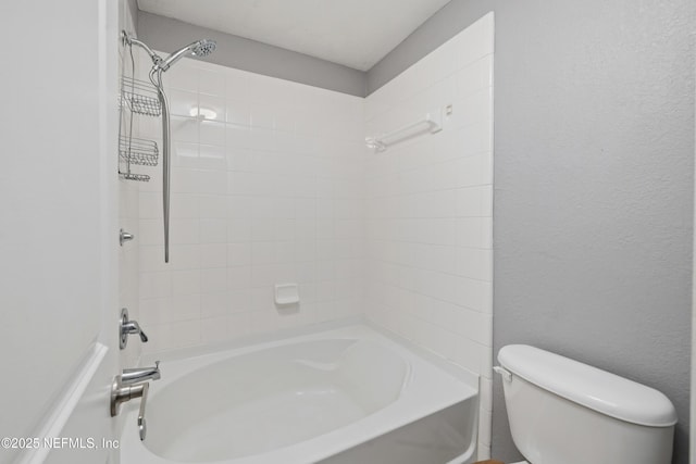 bathroom featuring shower / washtub combination and toilet