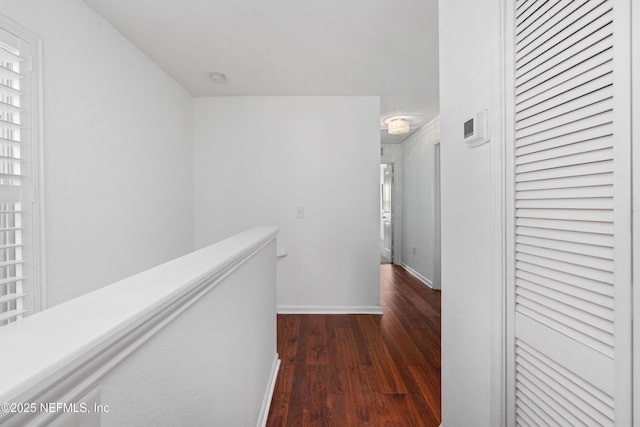 corridor with dark hardwood / wood-style floors