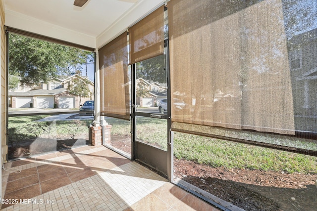 sunroom / solarium with ceiling fan and a healthy amount of sunlight