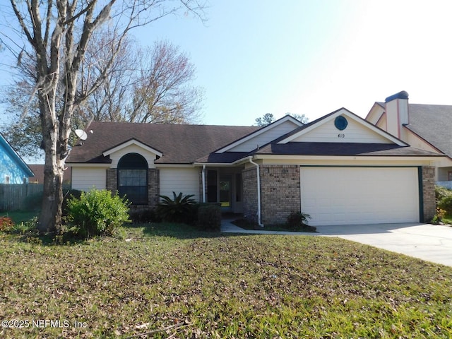 ranch-style house featuring a garage and a front lawn