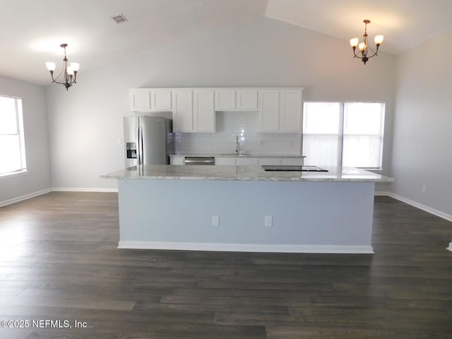 kitchen with white cabinets, stainless steel appliances, and an inviting chandelier