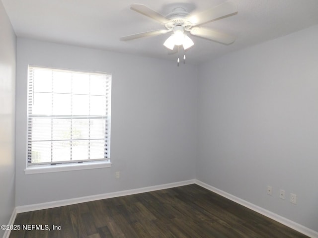 unfurnished room with dark hardwood / wood-style flooring, plenty of natural light, and ceiling fan