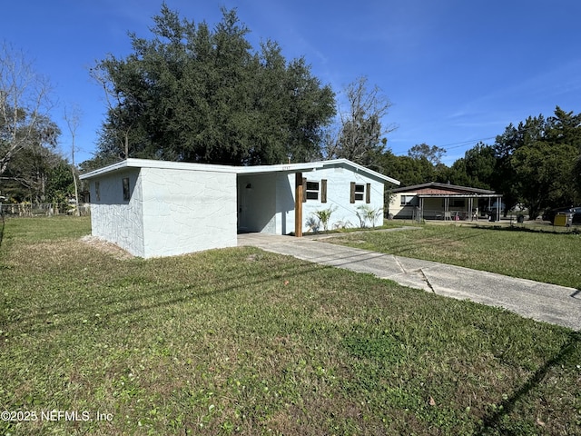 view of front facade with a carport and a front yard