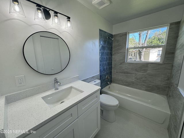 full bathroom with tiled shower / bath combo, toilet, and vanity