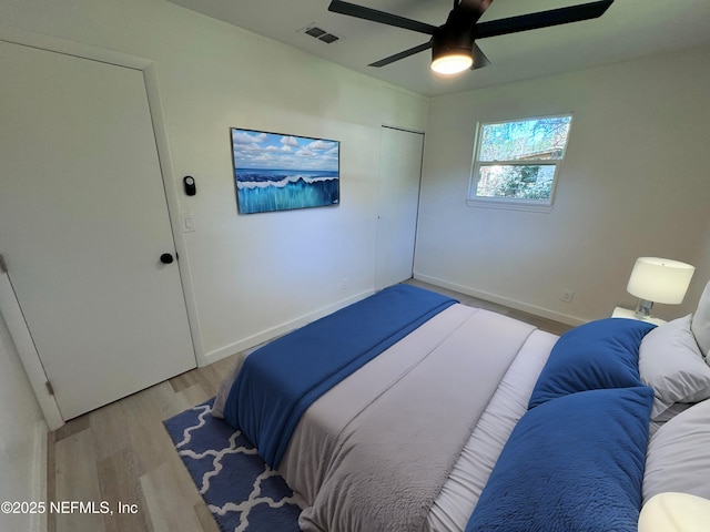 bedroom with light wood-type flooring and ceiling fan