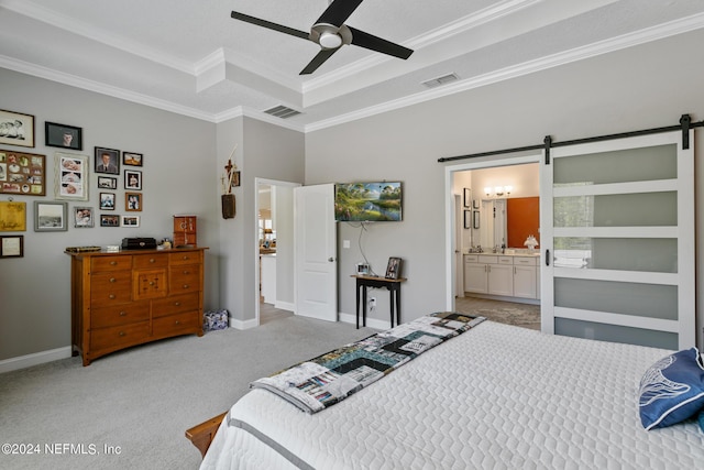 bedroom with ensuite bathroom, crown molding, carpet flooring, ceiling fan, and a barn door