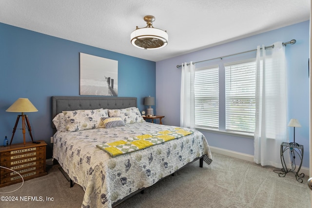 bedroom with carpet floors, multiple windows, and ceiling fan