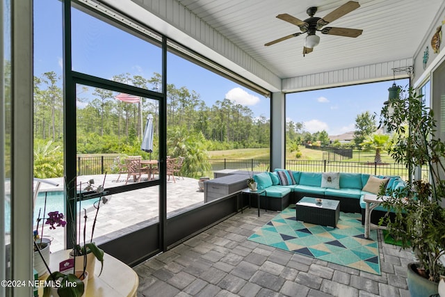 sunroom featuring ceiling fan and a healthy amount of sunlight