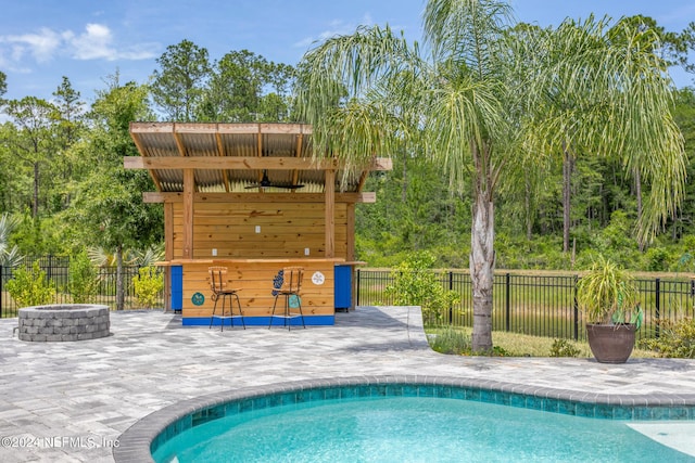 view of pool featuring a patio and an outdoor fire pit