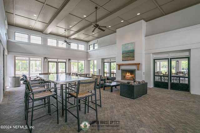 dining space featuring a high ceiling and ceiling fan