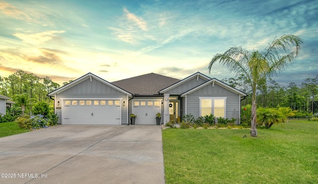 view of front of property with a yard and a garage