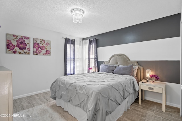 bedroom featuring a textured ceiling and light wood-type flooring