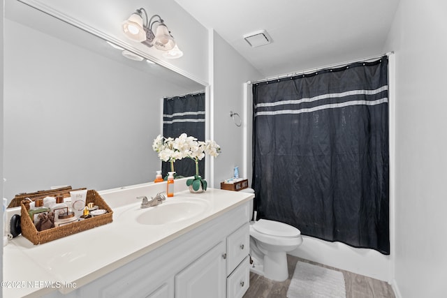 full bathroom with hardwood / wood-style floors, vanity, toilet, and shower / bathtub combination with curtain