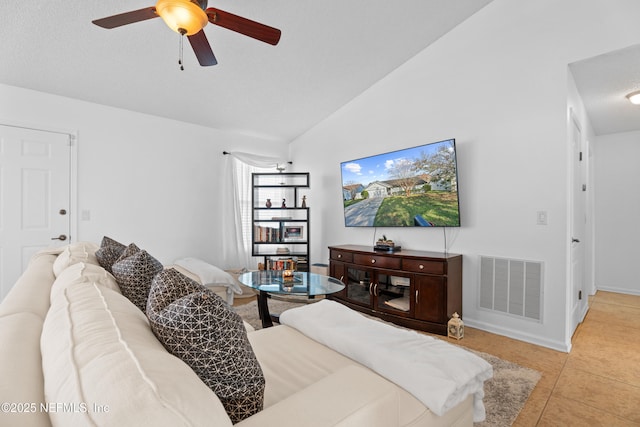 tiled living room featuring ceiling fan and lofted ceiling