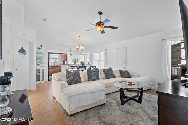 tiled living room with a textured ceiling, sink, ceiling fan with notable chandelier, and lofted ceiling