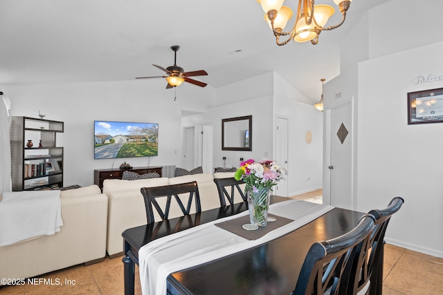 tiled dining room with ceiling fan with notable chandelier and lofted ceiling