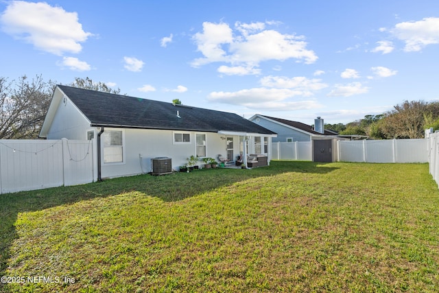 back of property featuring central AC unit and a lawn