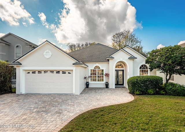 view of front facade with a garage and a front lawn