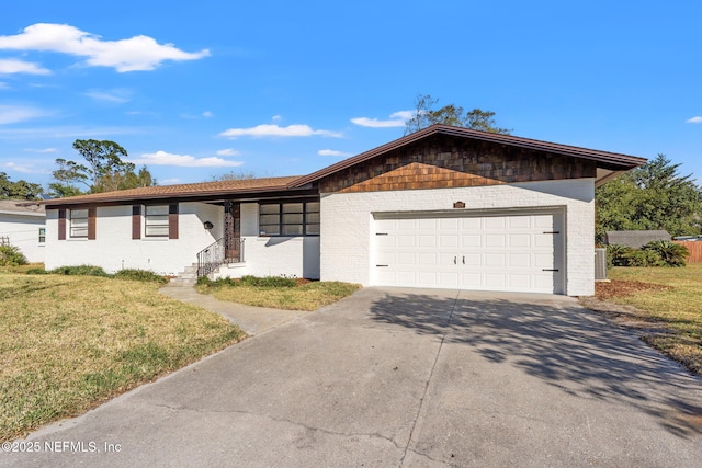 ranch-style home with a garage, central air condition unit, and a front lawn