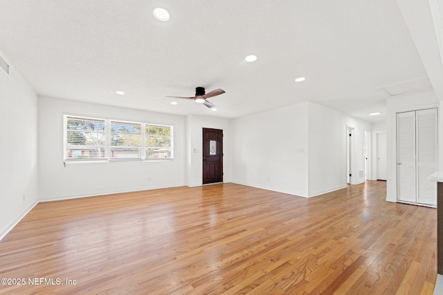 unfurnished living room with ceiling fan and light wood-type flooring