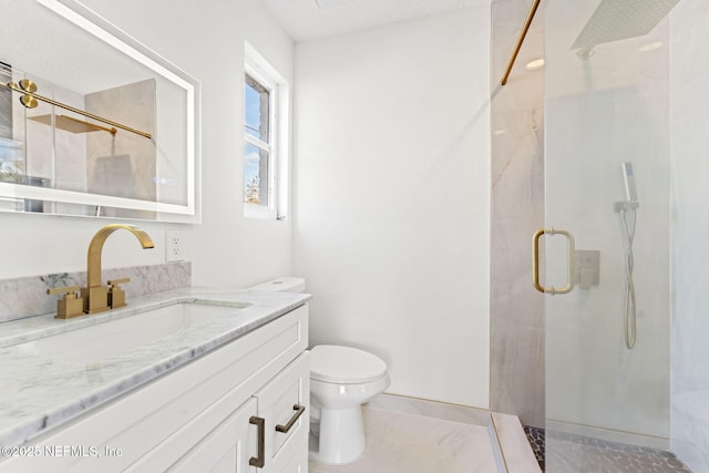 bathroom featuring vanity, toilet, and a shower with door