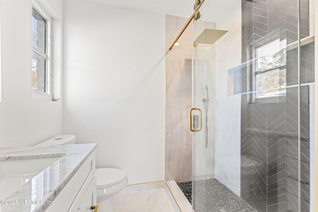 bathroom with vanity, toilet, a textured ceiling, and walk in shower