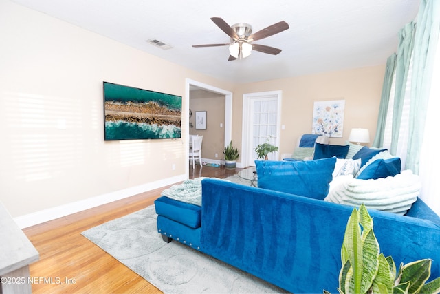 living room with ceiling fan and wood-type flooring