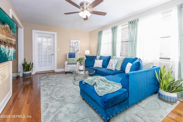 living room with hardwood / wood-style floors and ceiling fan