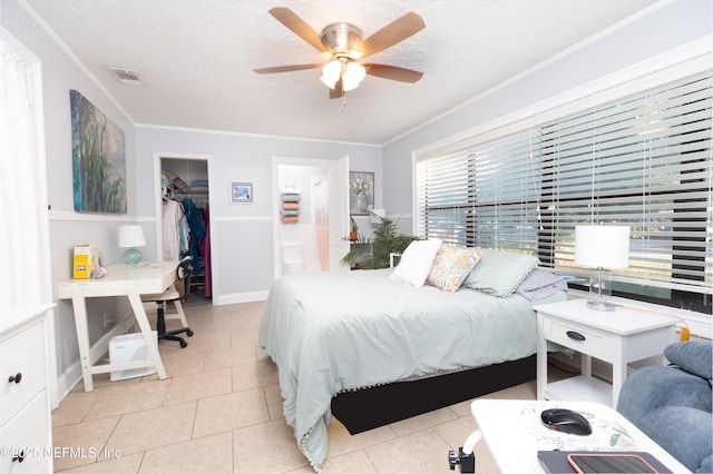 bedroom featuring ceiling fan, ornamental molding, and light tile patterned floors