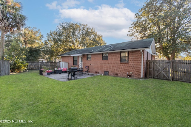 rear view of house featuring outdoor lounge area, a patio area, and a yard