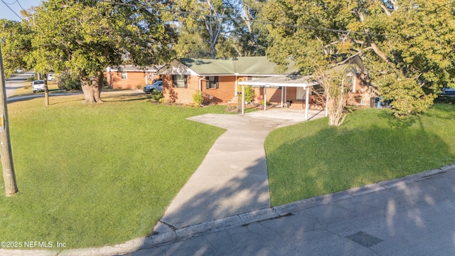 view of front of home with a carport and a front lawn