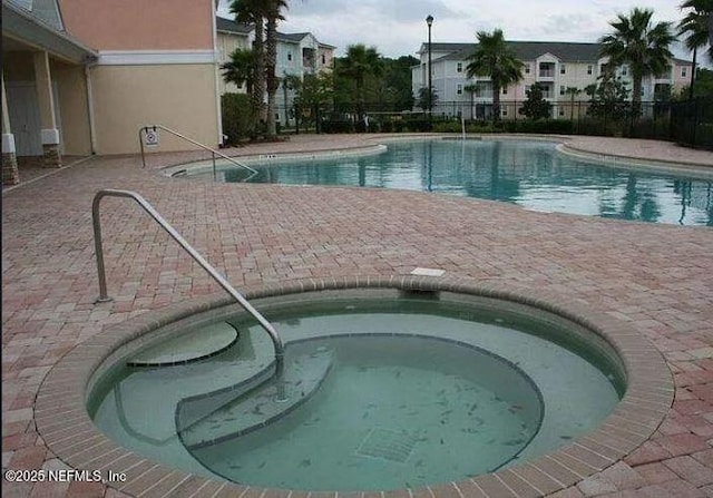 view of swimming pool with a community hot tub