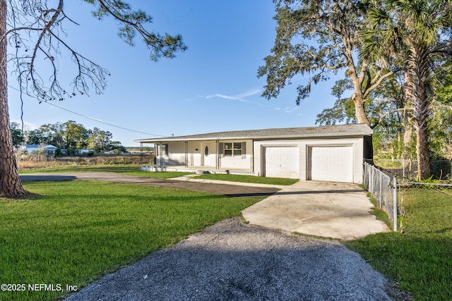 single story home with a porch, a garage, and a front lawn