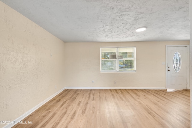 entrance foyer featuring light hardwood / wood-style flooring and a textured ceiling