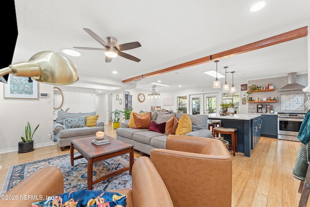 living room with ceiling fan, french doors, light hardwood / wood-style flooring, beamed ceiling, and a textured ceiling