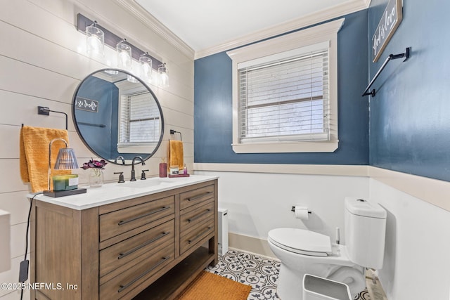 bathroom with vanity, toilet, and ornamental molding