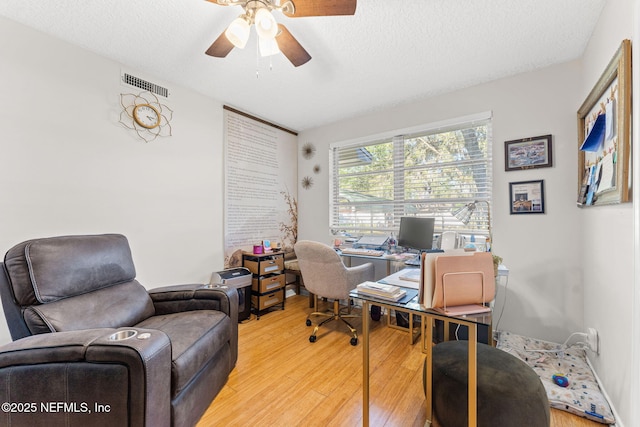 office area with ceiling fan, wood-type flooring, and a textured ceiling